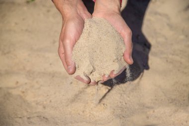 Sand quarry in the hands of a man. Selective focus. Nature.