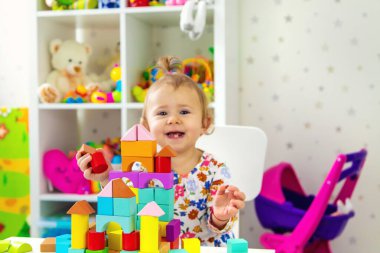 Çocuk odada oyuncaklarla oynuyor. Seçici odaklanma. Bebeğim..