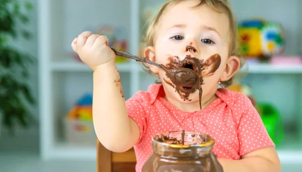 赤ん坊はチョコレートのお菓子をたくさん食べる 選択的フォーカス — ストック写真