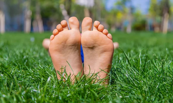 Çimlerin üzerinde çocuk ayakları. Seçici odaklanma. Doğa.