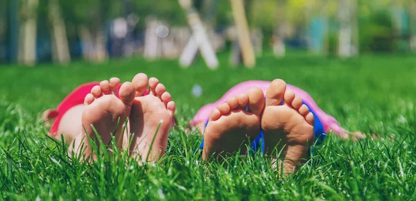 Çimlerin üzerinde çocuk ayakları. Seçici odaklanma. Doğa.