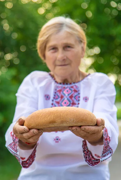 Grandmother Ukrainian Bread Her Hands Selective Focus Food — Stock Photo, Image