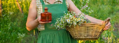 Bir kadın bitkisel tentür üretiyor. Seçici odaklanma. Doğa.