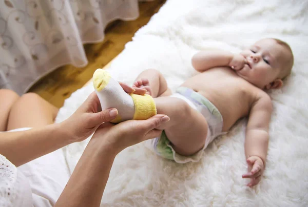 Mother Puts Socks Little Baby Selective Focus People — Stock Photo, Image