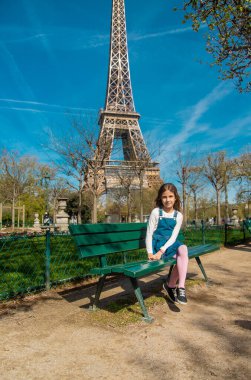 Children in Paris near the Eiffel Tower. Selective focus. Kid.