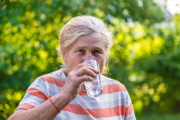 Grandmother Drinks Water Glass Selective Focus Drink — Stockfoto