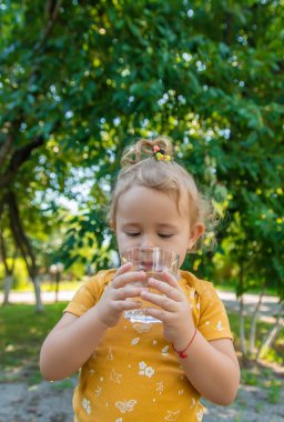 Çocuk bardaktan su içiyor. Seçici odaklanma. Çocuk.
