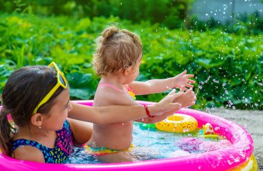 Children swim in the pool. Selective focus. Kid.