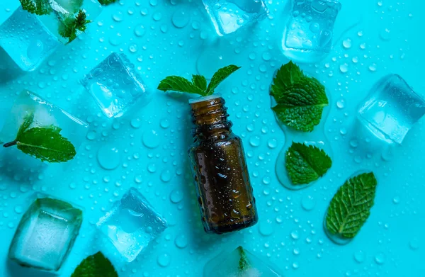 Peppermint essential oil with ice cubes. Selective focus. Nature.