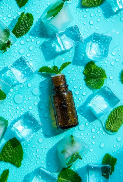 Peppermint essential oil with ice cubes. Selective focus. Nature.