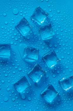 Ice cubes on a blue background. Selective focus. Food.