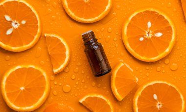Essential oil of orange on a yellow background. Selective focus. Spa.