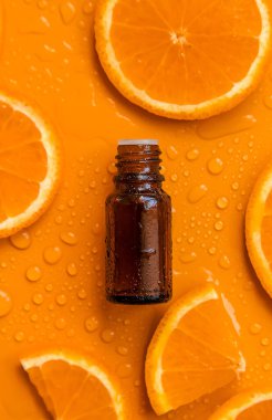 Essential oil of orange on a yellow background. Selective focus. Spa.