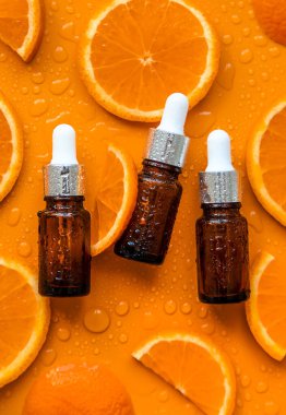 Essential oil of orange on a yellow background. Selective focus. Spa.
