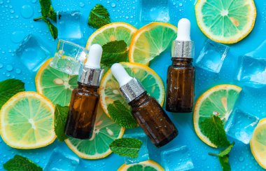 Peppermint essential oil with ice cubes and lemon. Selective focus. Nature.