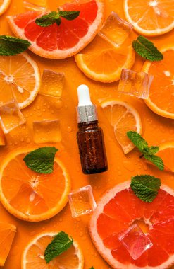Essential oil of orange on a yellow background. Selective focus. Spa.