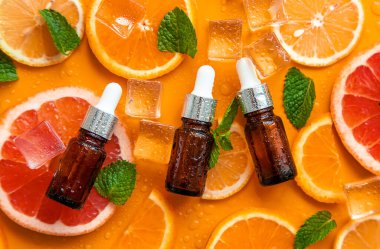 Essential oil of orange on a yellow background. Selective focus. Spa.