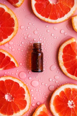 Grapefruit essential oil in a bottle. Selective focus. Spa.