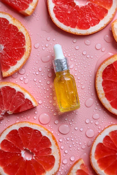 Grapefruit essential oil in a bottle. Selective focus. Spa.