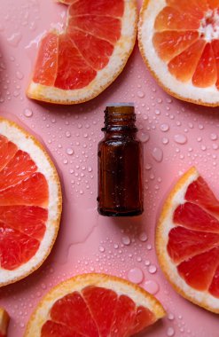 Grapefruit essential oil in a bottle. Selective focus. Spa.