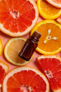 Essential oil of orange on a yellow background. Selective focus. Spa.