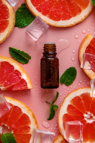 Grapefruit essential oil in a bottle. Selective focus. Spa.