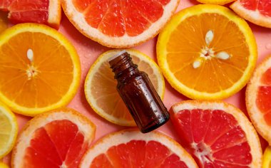 Essential oil of orange on a yellow background. Selective focus. Spa.