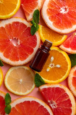 Essential oil of orange on a yellow background. Selective focus. Spa.