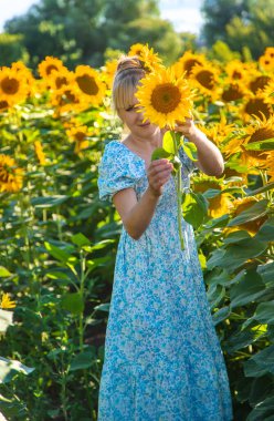Woman in a field of sunflowers. Ukraine. Selective focus. Nature.
