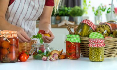 Woman jar preserve vegetables in the kitchen. Selective focus. Food.