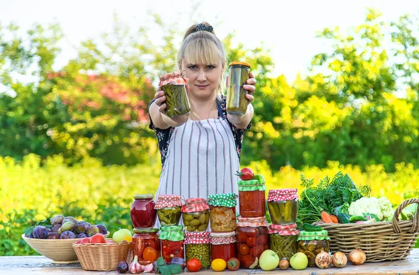 Woman with jar preserved vegetables for winter. Selective focus. Food.