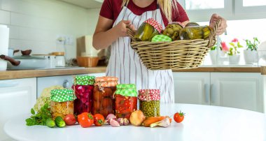 Woman jar preserve vegetables in the kitchen. Selective focus. Food.