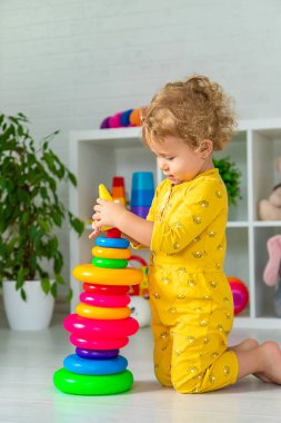 Children play with toys in the room. Selective focus. Kid.