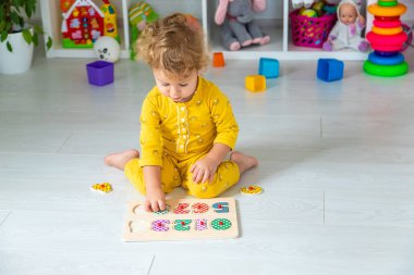 Children play with toys in the room. Selective focus. Kid.