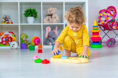 Children play with toys in the room. Selective focus. Kid.
