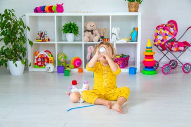 Child drink milk in the room. Selective focus. Kid.