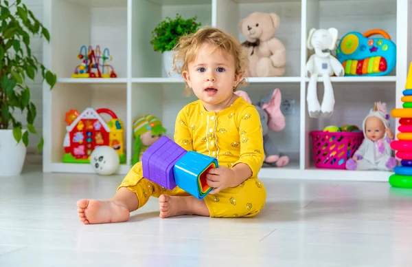 Children play with toys in the room. Selective focus. Kid.