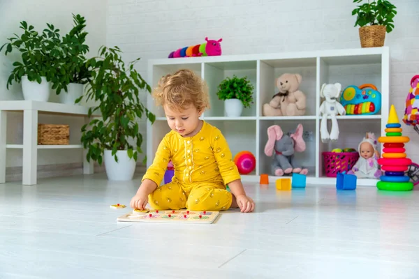 Children play with toys in the room. Selective focus. Kid.