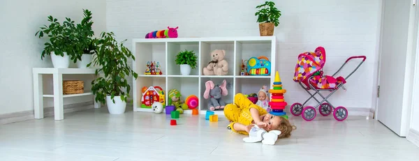 Children play with toys in the room. Selective focus. Kid.