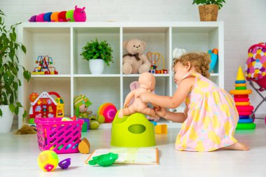 Children sit on the potty in the room. Selective focus. Kid.