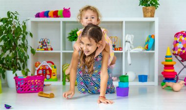 Children play together in the room. Selective focus. Kids,