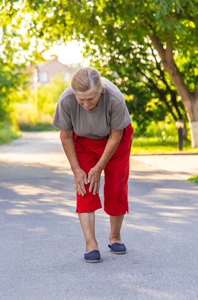 Grandmother Hurts Her Knee Road Selective Focus People — Stockfoto