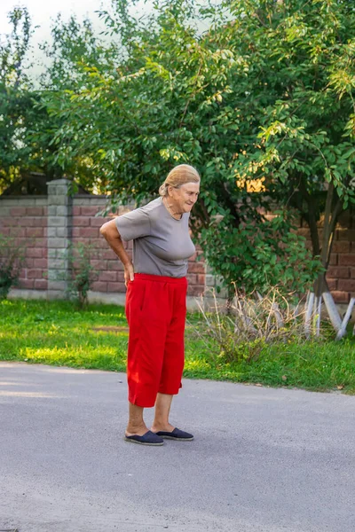 Grandmother Hurts Her Back Road Selective Focus Nature — Fotografia de Stock