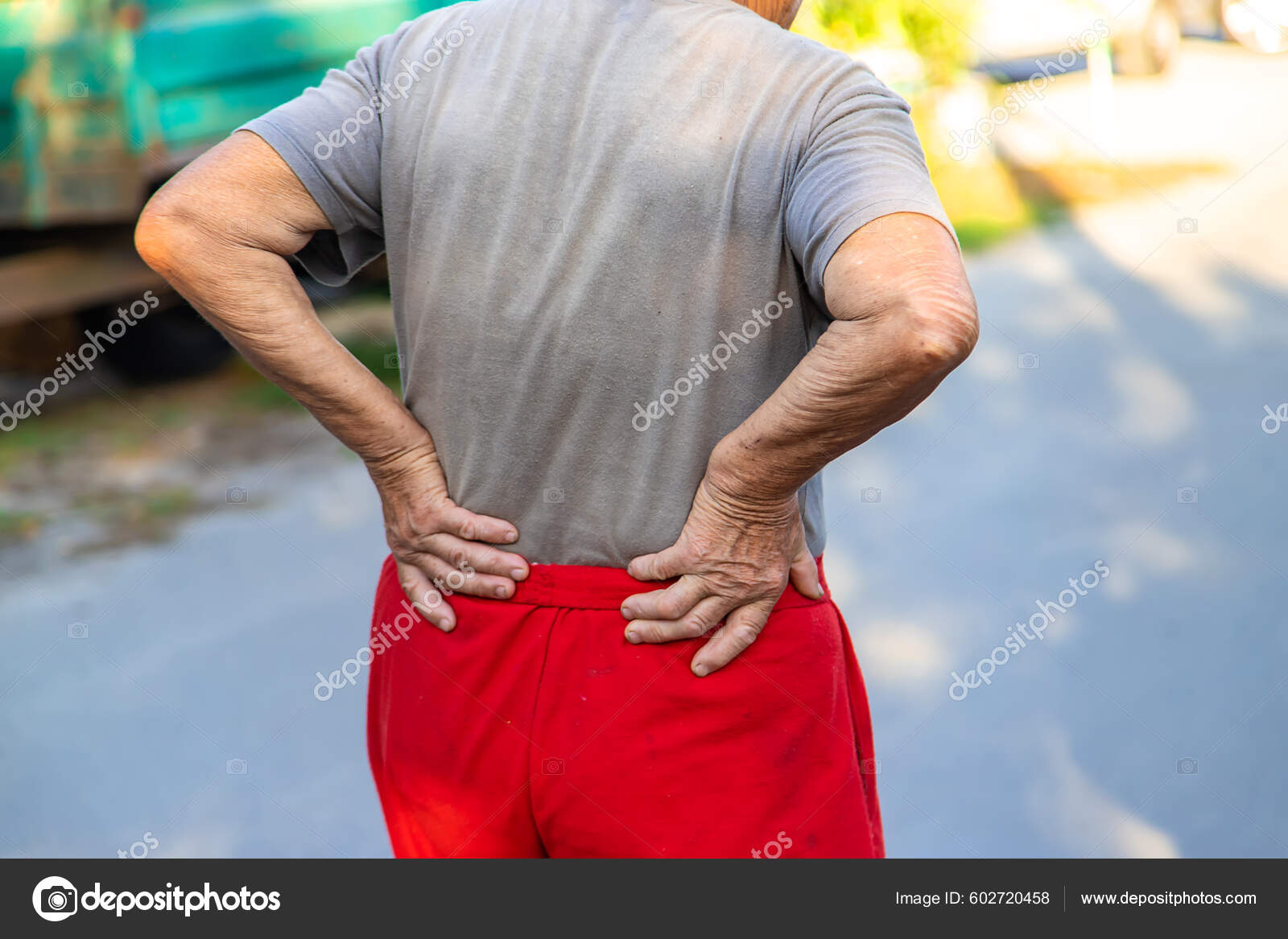 Grandmother Hurts Her Back Road Selective Focus Nature Stock Photo.