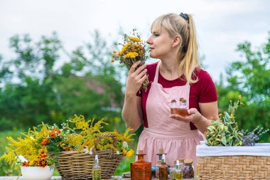 Woman with medicinal herbs and tinctures. Selective focus. Nature.