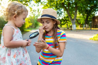 The child is playing with the frog. Selective focus. Kid.