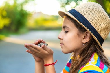 The child is playing with the frog. Selective focus. Kid.