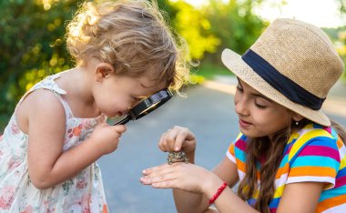 The child is playing with the frog. Selective focus. Kid.