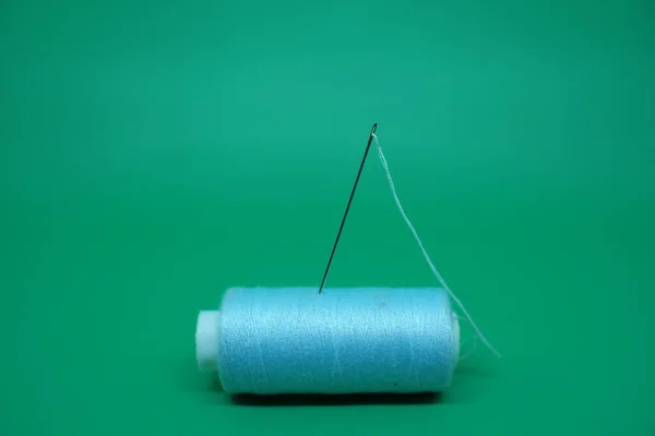 Sewing needle stuck in thread.