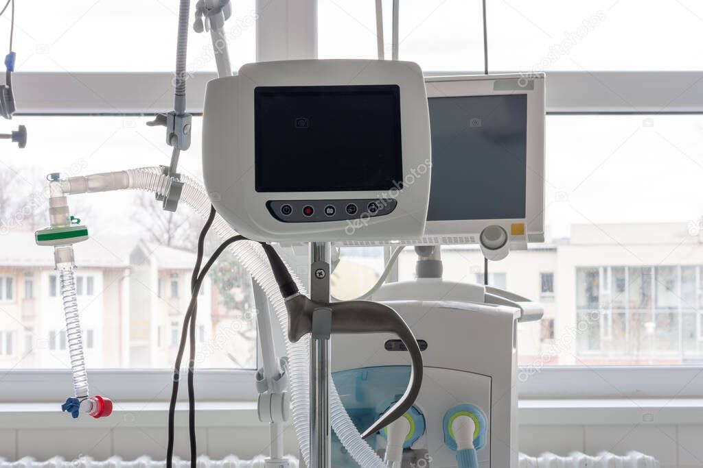Video laryngoscope , on background medical ventilator in ICU in hospital. Video laryngoscope with separate screens to keep doctors away from patients.